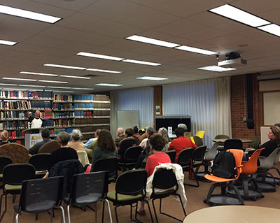 An audience listening to a speaker.