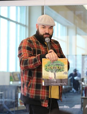 Poet standing in front of microphone.