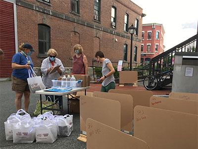 People standing at a distribution site table