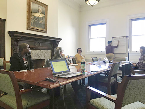 People sitting at a conference room table inside the Carnegie Library of Pittsburgh