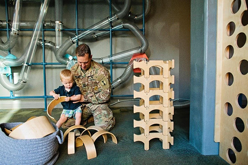Father and child playing with building toys