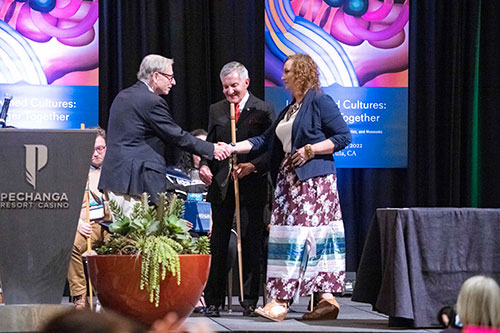 Crosby Kemper shaking hands on stage.