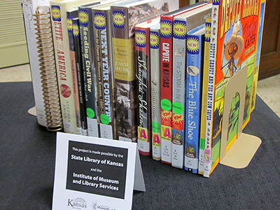 display of notable books with signage referencing the State Library of Kansas and IMLS