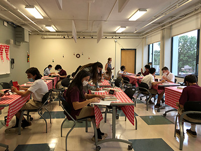 Bishop Stang High School students at tables for book tasting event