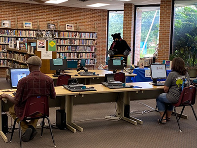 two people seated at library computer stations
