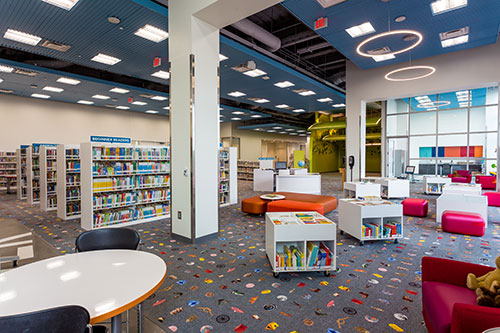 Library interior with bookshelves and reading tables.