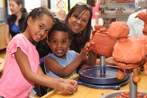 Museum visitors creating clay sculptures.