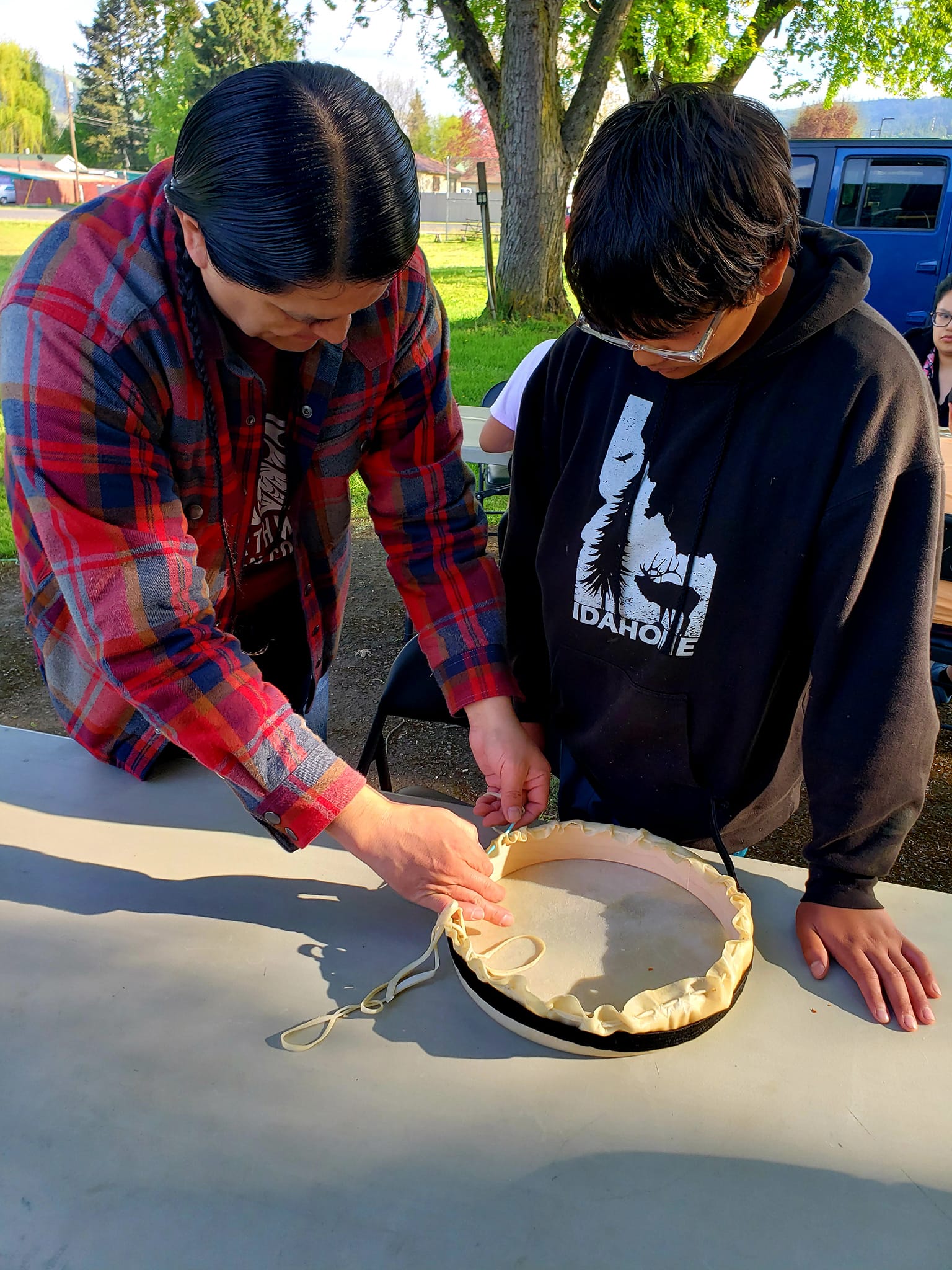 man and youth drum making 