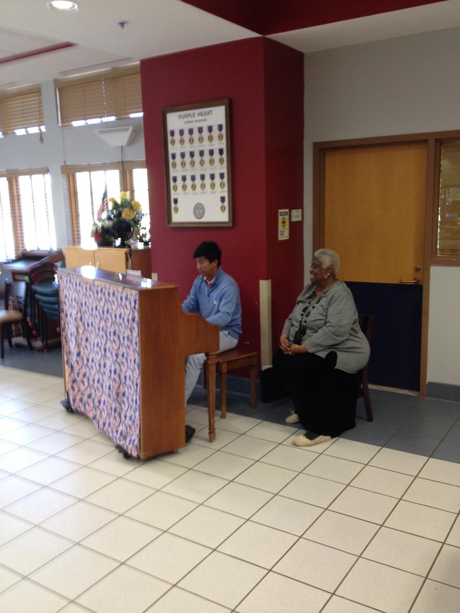 (Photo Courtesy of National Student Poets Program: David playing the hymn that one female veteran wrote during the writing workshop.)