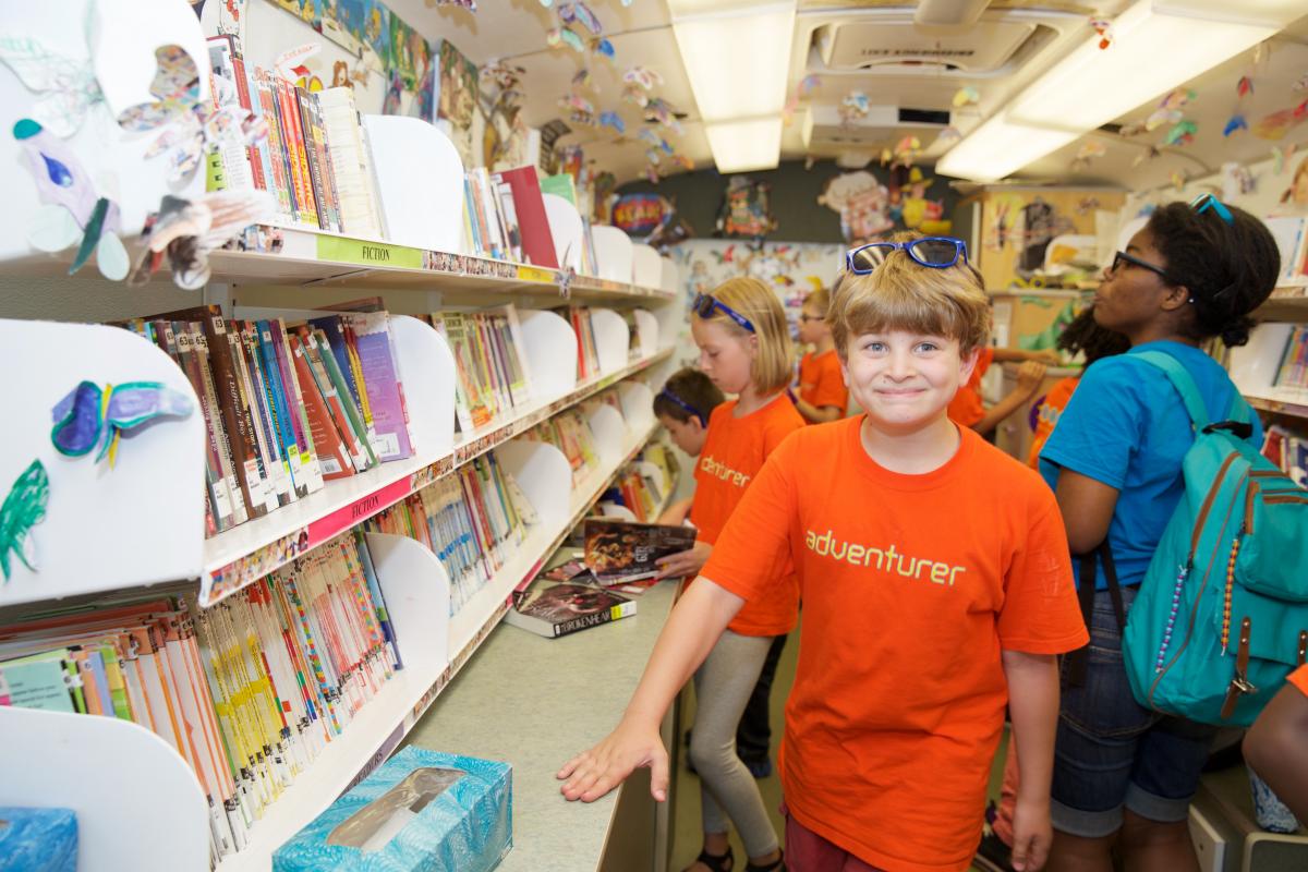 a boy age 11 explores a bookmobile