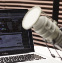 photo of a digital microphone next to a laptop computer