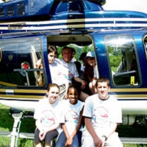 Sky Camp particpants pose in front of a state police helicopter.