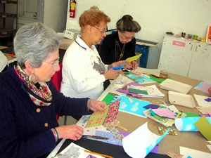 three class participants create art projects