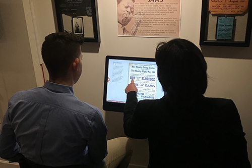 Visitors using a kiosk at the museum