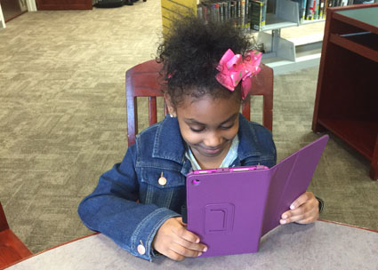 Six-year-old Zyasia Salter explores the Open eBook app at the Seymour Wilson Branch Library, New Haven Free Public Library. The system is purchasing 3 tablets for each of its five locations to accommodate in-library use and to offer content to kids who don’t have devices at home. Photo courtesy of Courtland Seymour Wilson Branch Library, New Haven Free Public Library (CT).