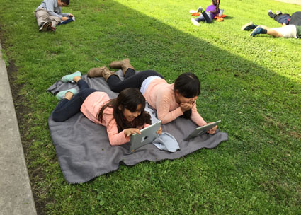 Veronica Hidalgo of Magee Academy asked her students to end the week with 30 minutes of unwinding with a good read. She told them, “Grab an iPad, find a spot outside, launch Open eBooks, and enjoy the books you selected.” Photo courtesy of Magee Academy.