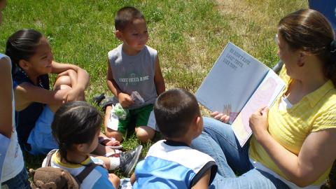 Children sitting at a library outreach reading circle