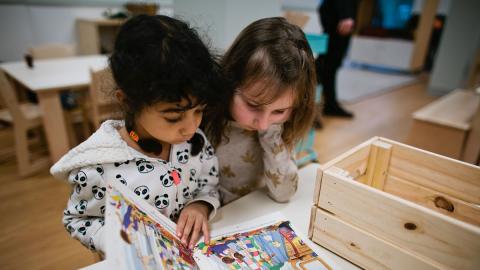 Two girls interacting with museum activity. Photo courtesy of Children’s Museum on Joint Base Lewis-McChord (JBLM)