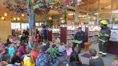 Members of the Ketchikan Fire Department reading stories and teaching fire safety at storytime.