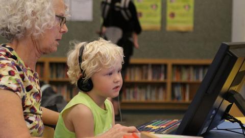 Child learning on accessible computer, Dakota County Library