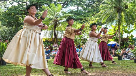 Women dressed in traditional clothes for a Hula performance.