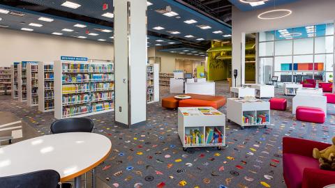 Library interior with bookshelves and reading tables